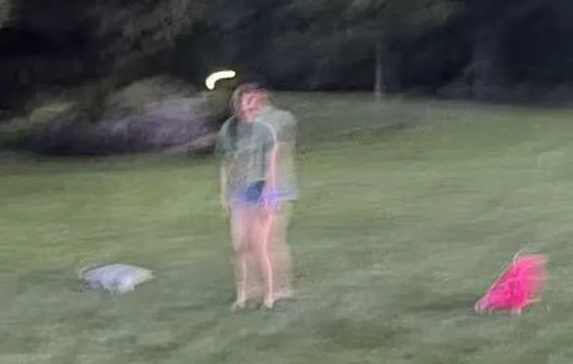 Nicole standing as a goalkeeper on a field at dusk